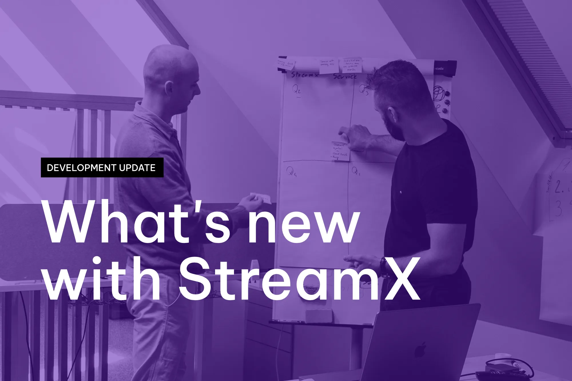 Two men discussing and placing sticky notes on a whiteboard in an office setting, with overlaid text reading 'Development Update: What's new with StreamX'.